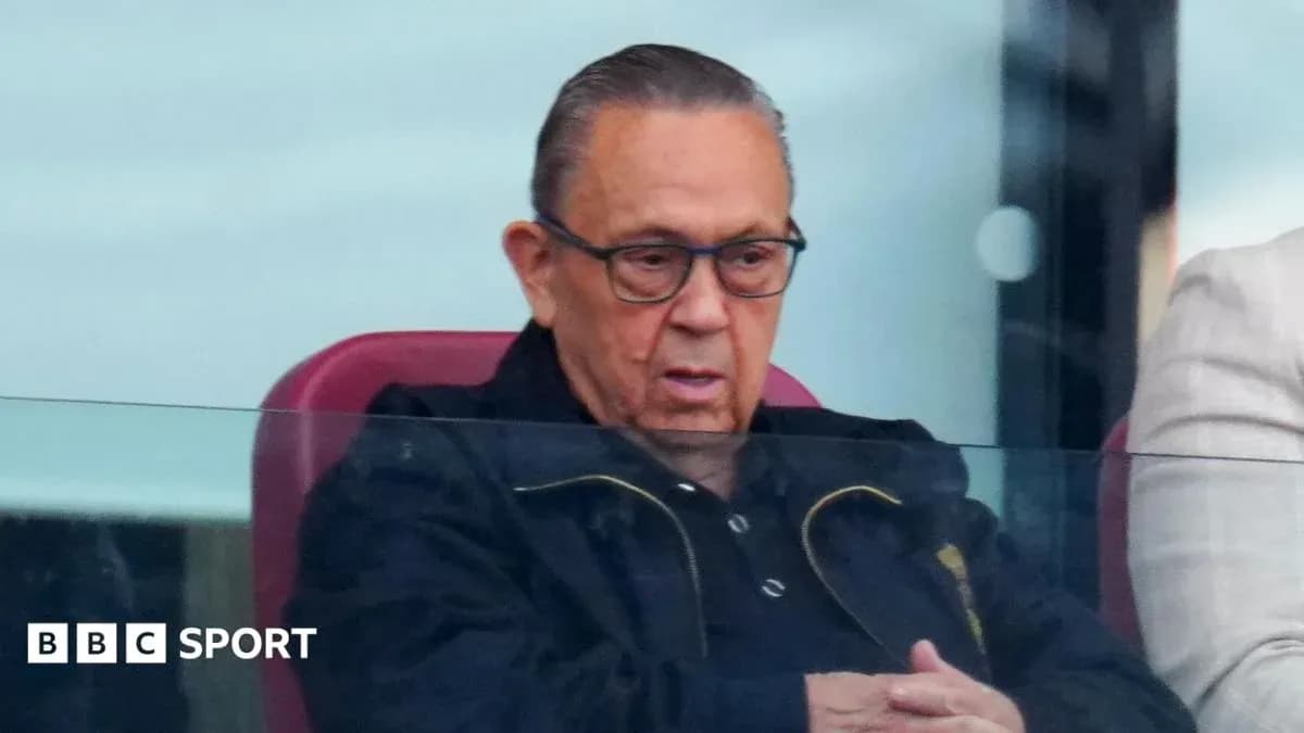 Man sitting in stadium box watching match Man sitting in stadium box watching match