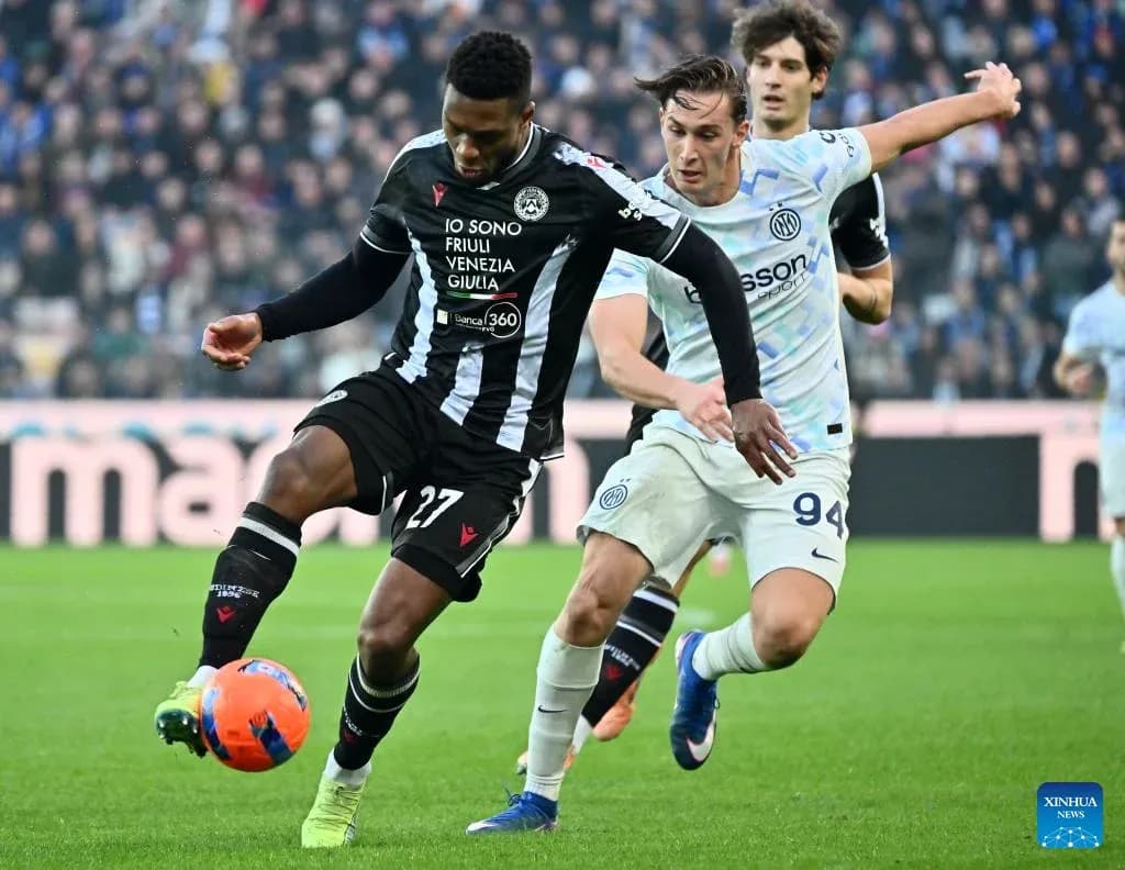 Player from Udinese challenged by Inter player Player from Udinese challenged by Inter player