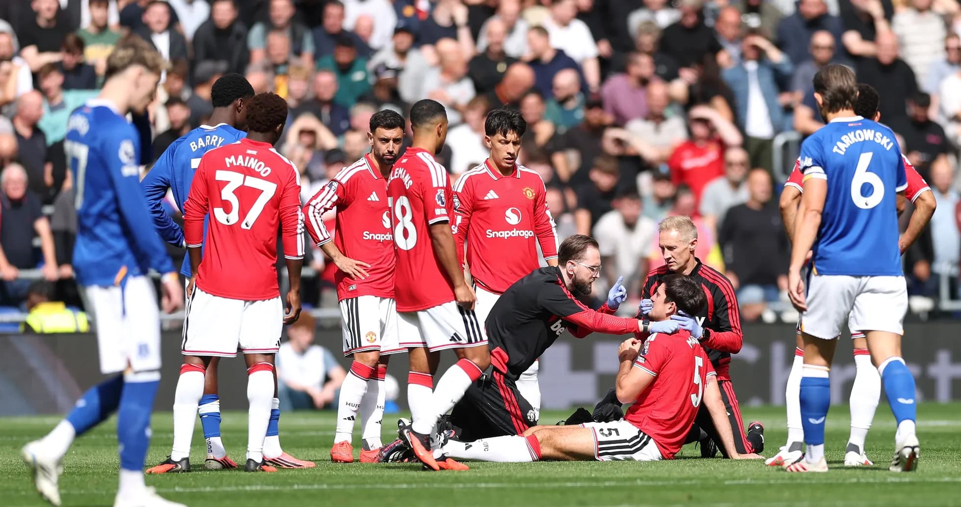 Medical staff attending to injured player on field Medical staff attending to injured player on field