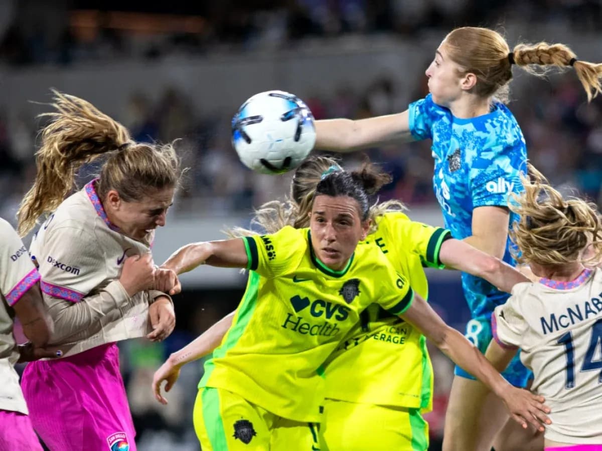 Players competing for the ball during NWSL match Players competing for the ball during NWSL match