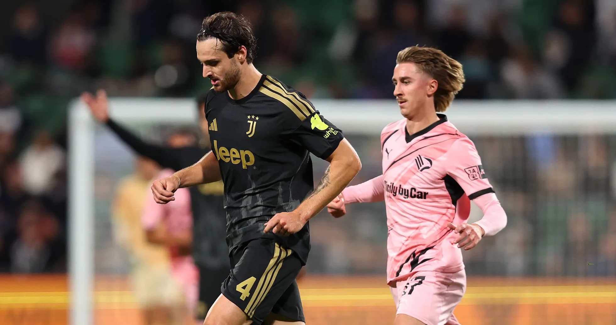 Juventus player running with ball, opponent chasing Juventus player running with ball, opponent chasing