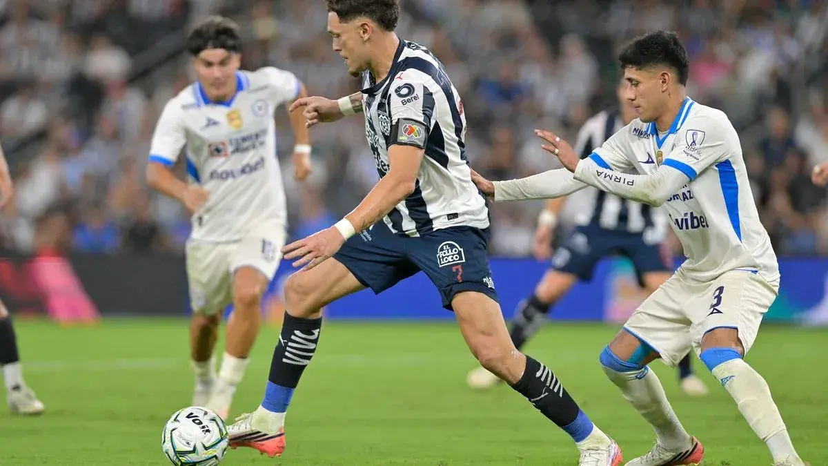 Monterrey player dribbling past Cruz Azul defenders Monterrey player dribbling past Cruz Azul defenders