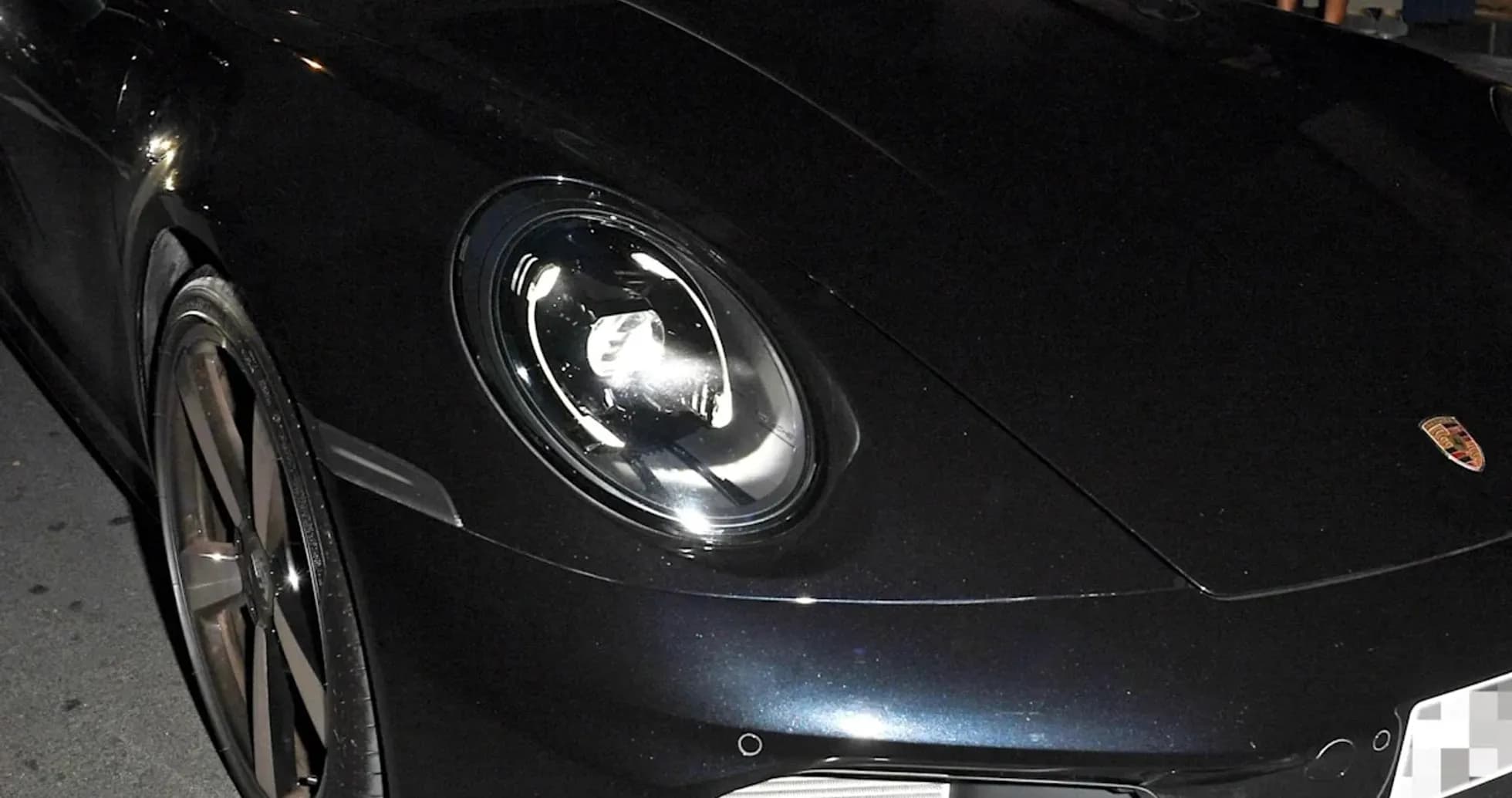 Two men in a black Porsche car at night Two men in a black Porsche car at night