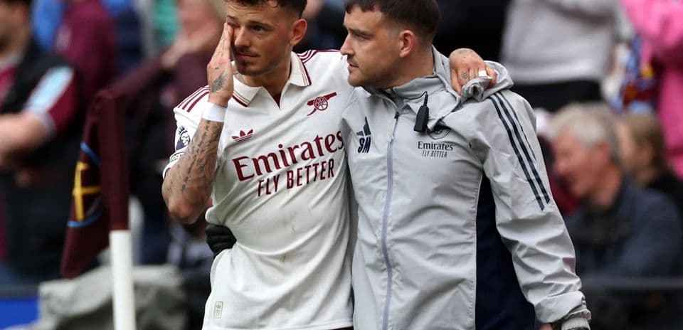 Player receiving support from staff after injury Player receiving support from staff after injury