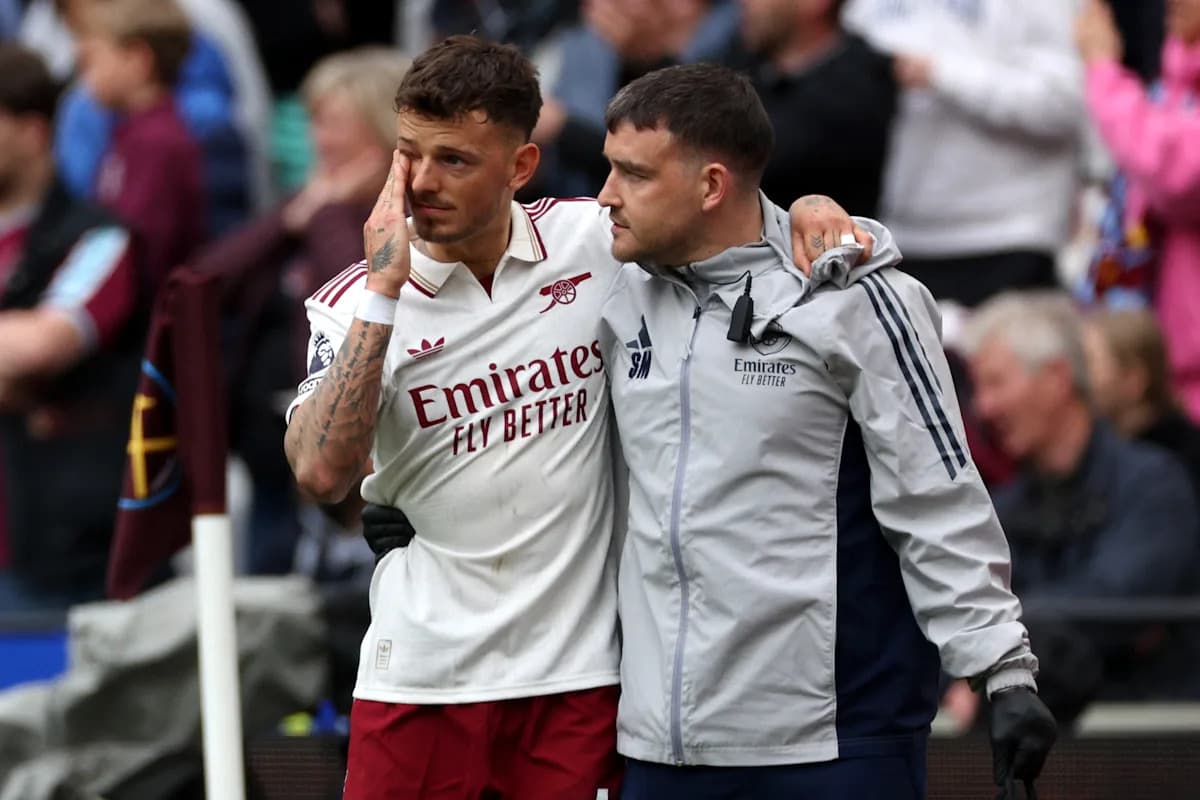 Player receiving support from staff after injury Player receiving support from staff after injury
