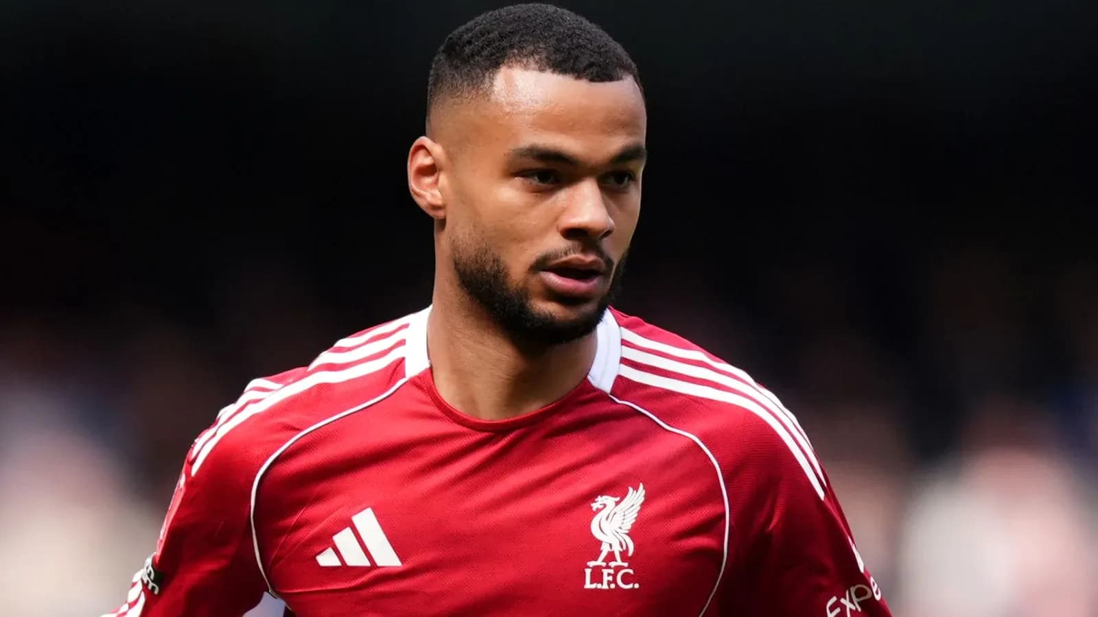 Player in Liverpool FC kit during match action Player in Liverpool FC kit during match action