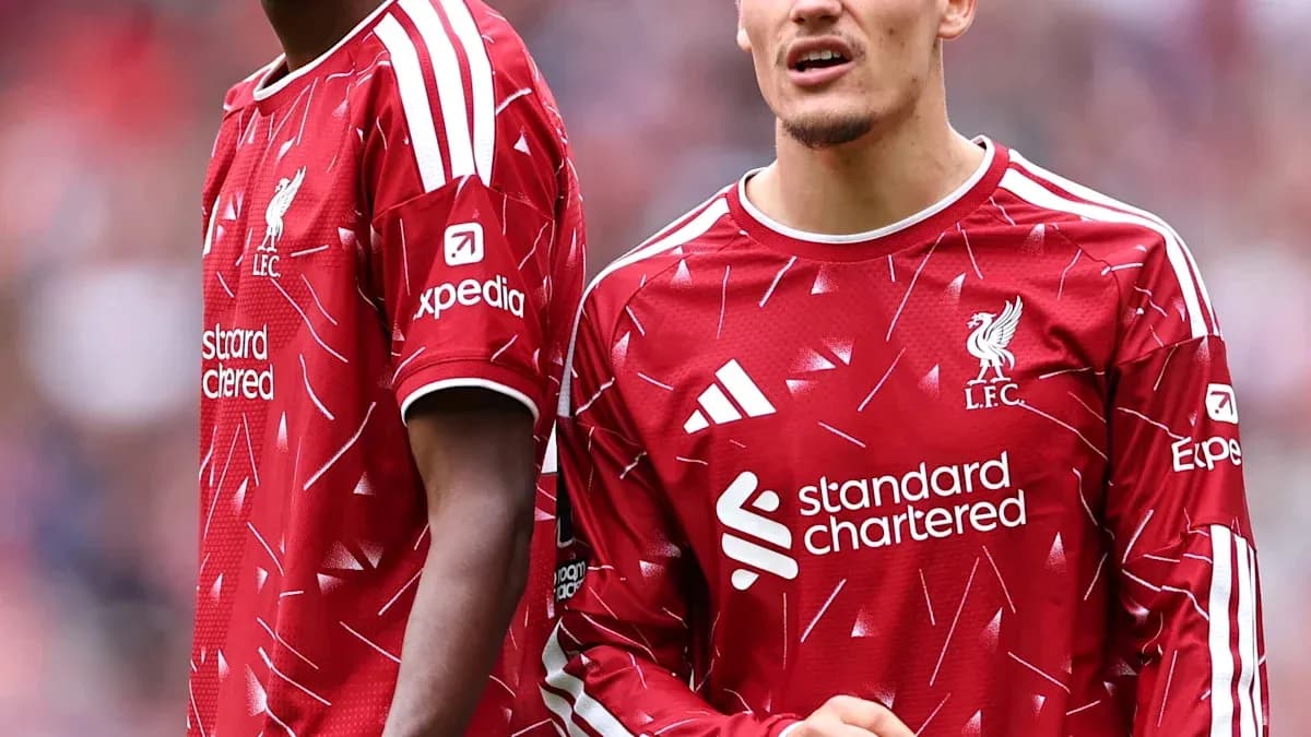 Two Liverpool players in red kits on the field Two Liverpool players in red kits on the field