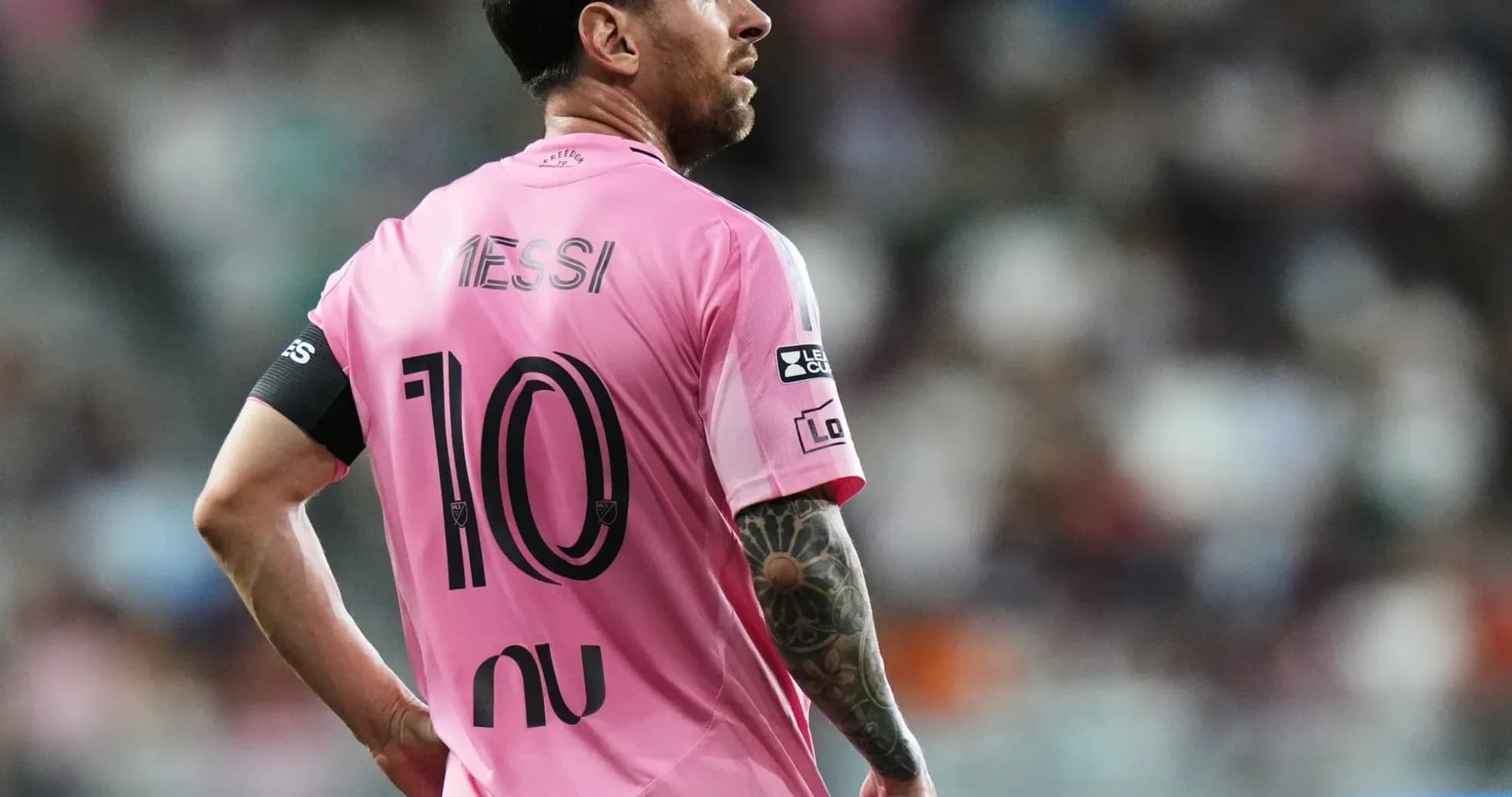 Player in pink jersey looking away on field Player in pink jersey looking away on field