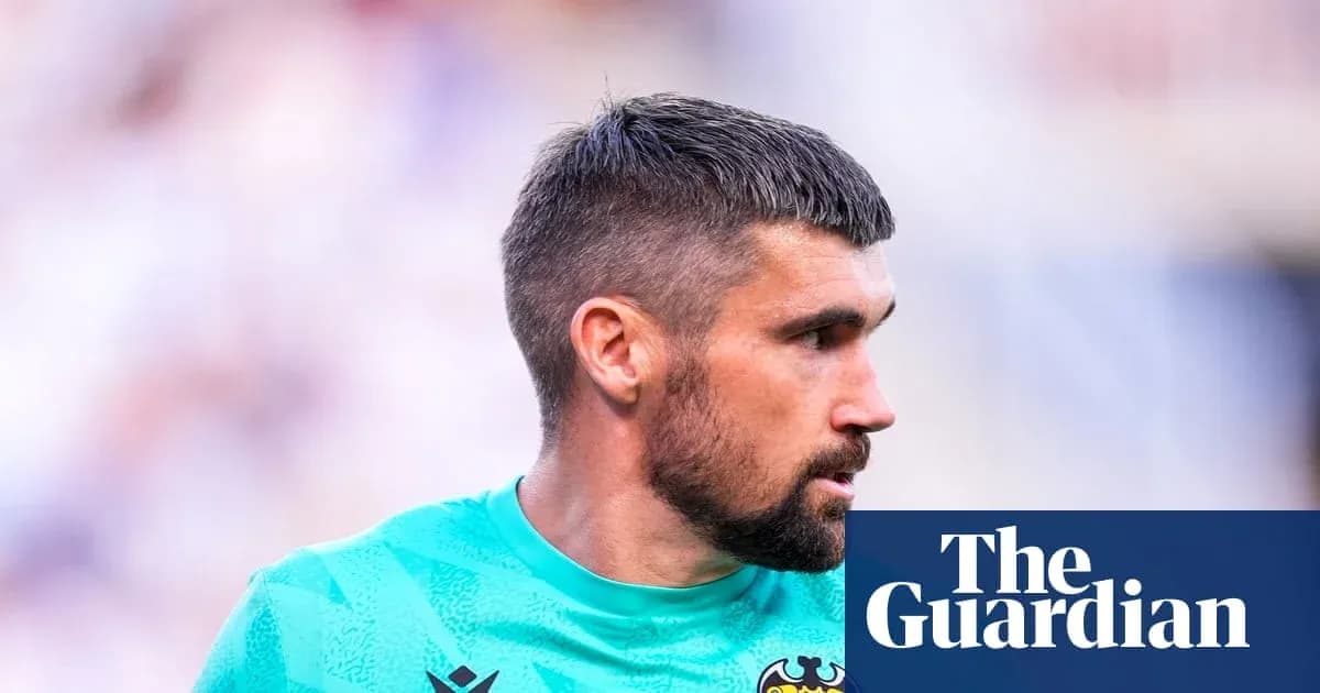 Goalkeeper in green kit during match action Goalkeeper in green kit during match action
