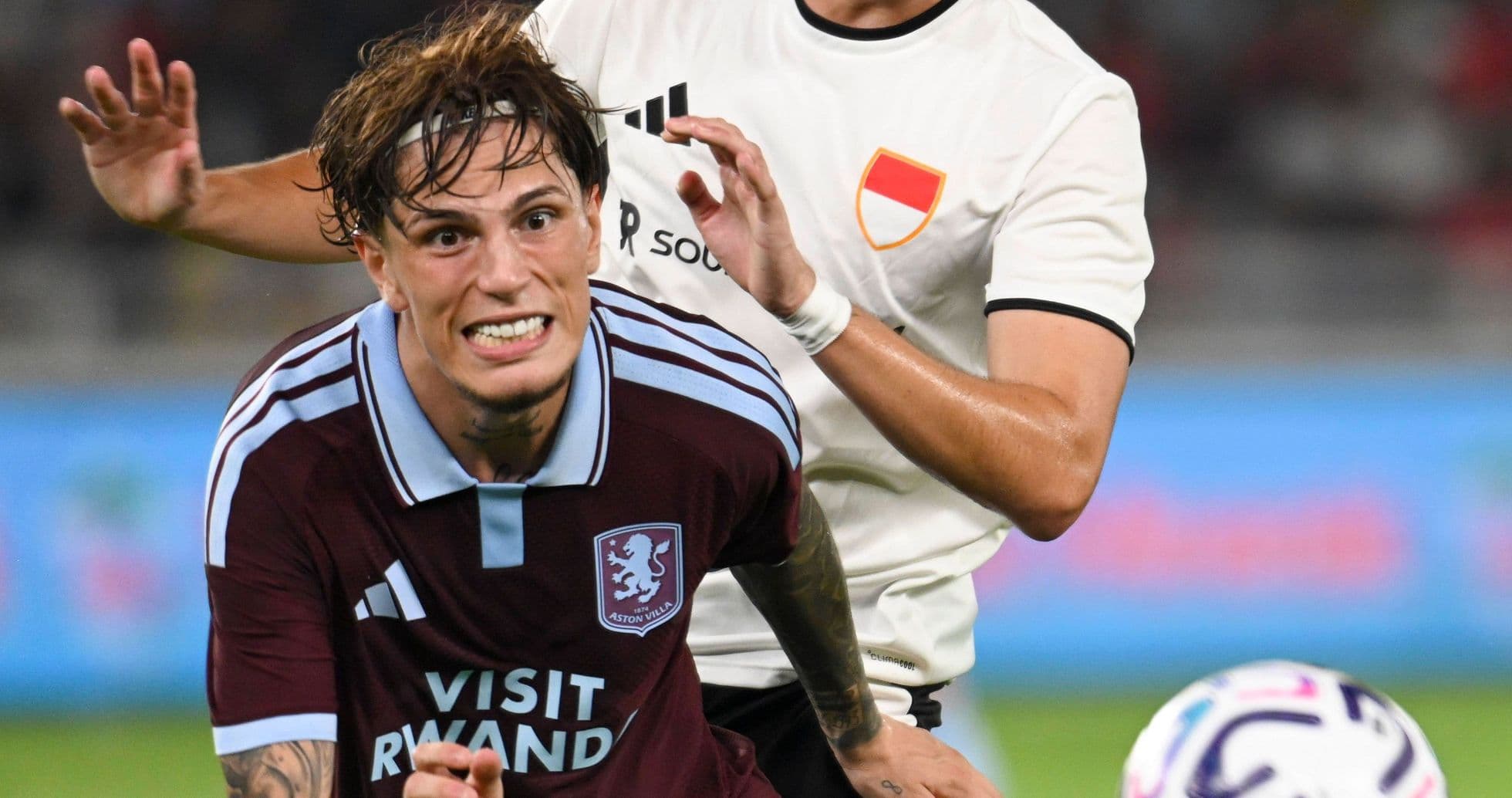 Player being challenged during a football match Player being challenged during a football match