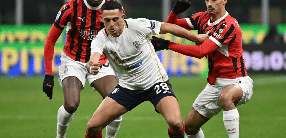 AC Milan players challenging Cagliari for the ball AC Milan players challenging Cagliari for the ball