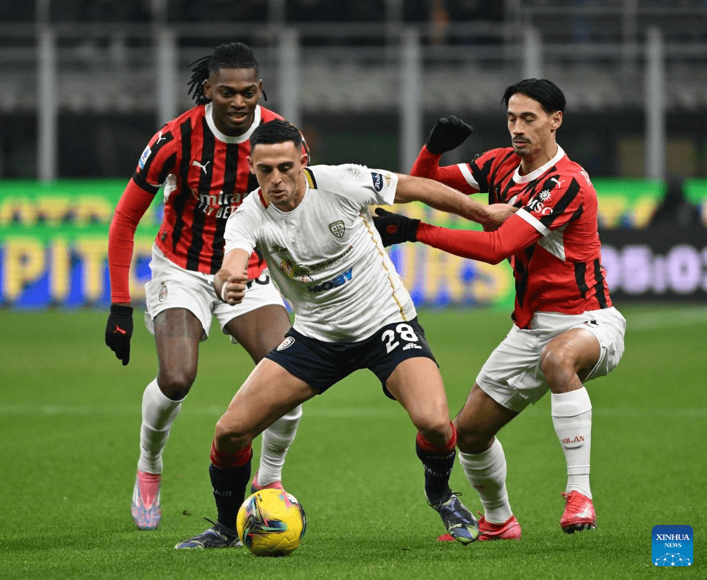 AC Milan players challenging Cagliari for the ball AC Milan players challenging Cagliari for the ball