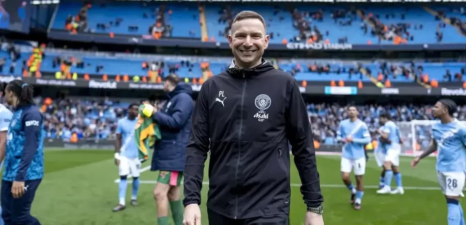 Coach walking off pitch after match at Etihad Stadium Coach walking off pitch after match at Etihad Stadium