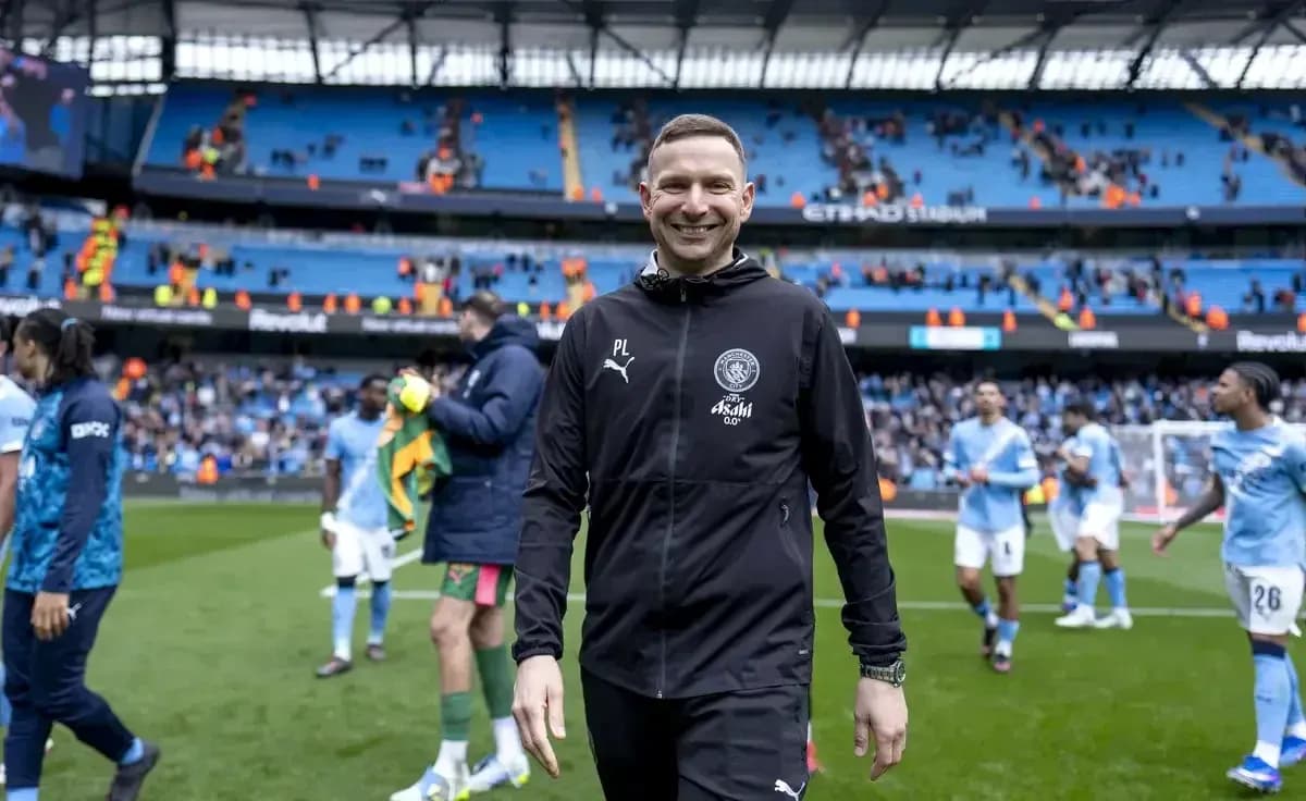Coach walking off pitch after match at Etihad Stadium Coach walking off pitch after match at Etihad Stadium