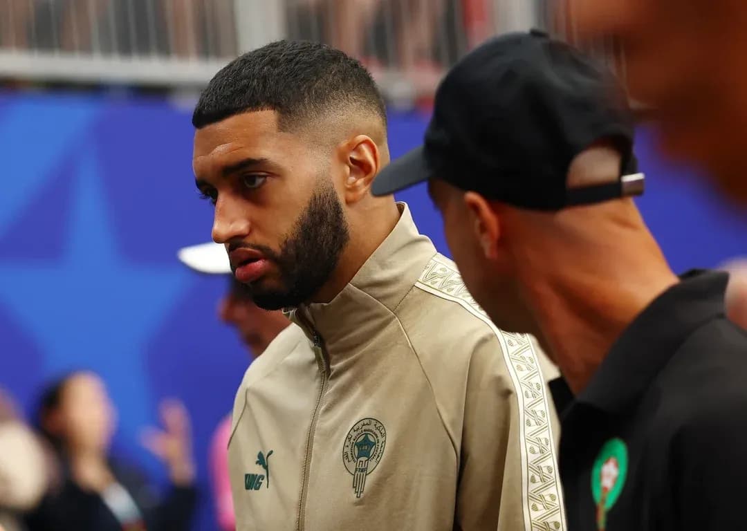 Player in Morocco tracksuit talking with teammate Player in Morocco tracksuit talking with teammate