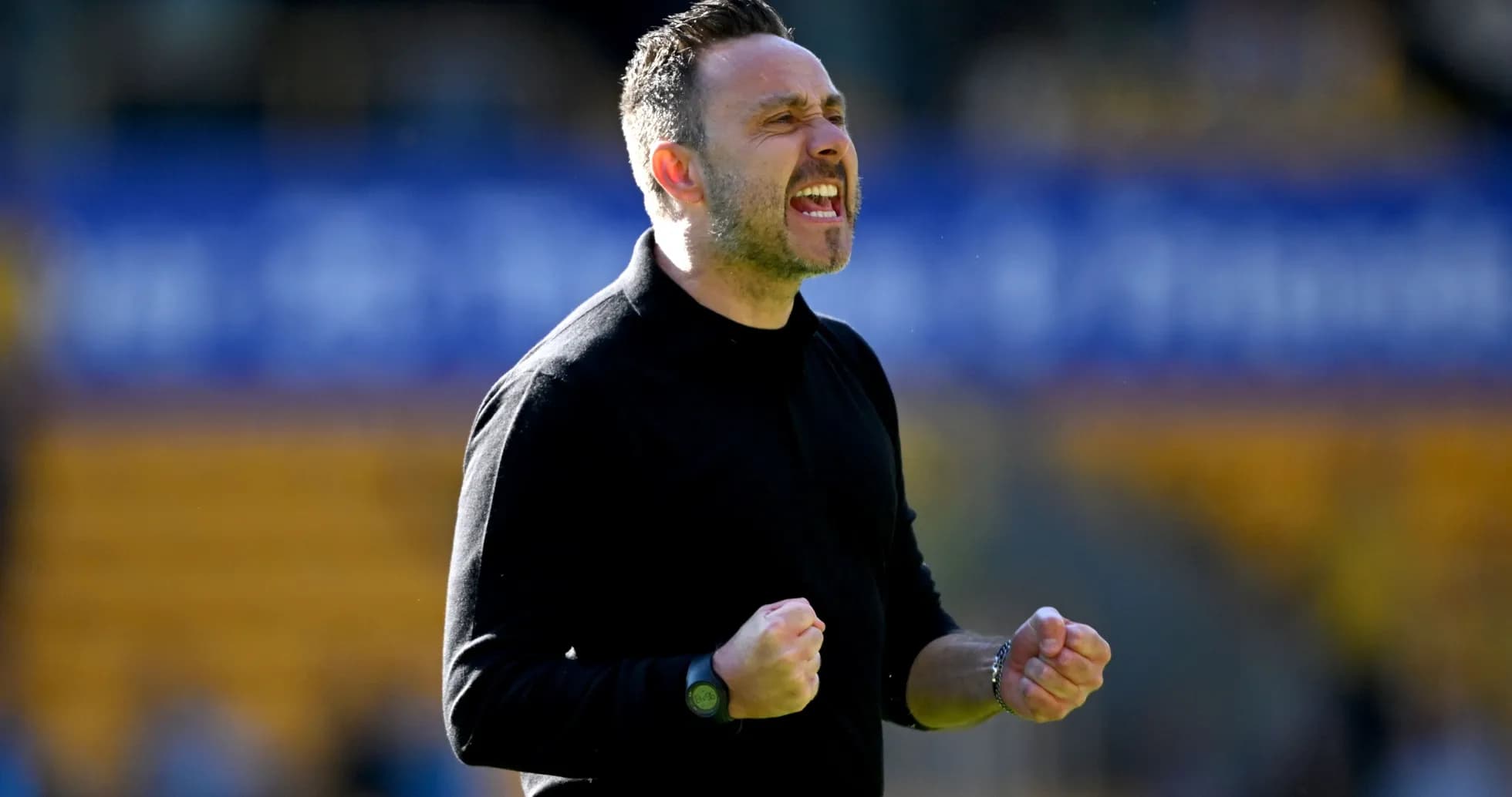 Coach celebrating with clenched fists on the sidelines Coach celebrating with clenched fists on the sidelines