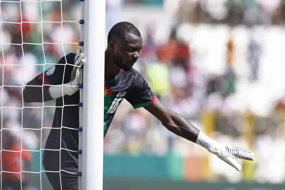 Goalkeeper signaling from behind the goalpost Goalkeeper signaling from behind the goalpost