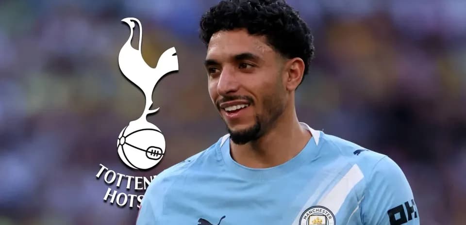 Player smiling in Manchester City kit with Tottenham logo Player smiling in Manchester City kit with Tottenham logo