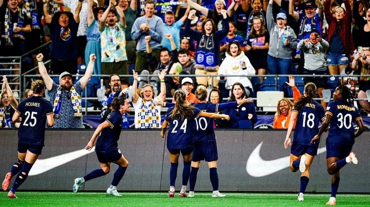 Players celebrating goal with enthusiastic crowd Players celebrating goal with enthusiastic crowd