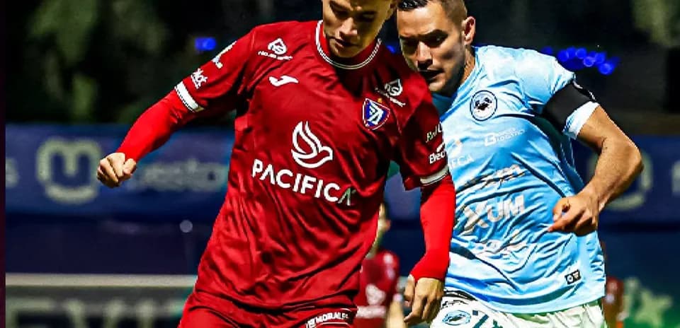 Two players competing for the ball in football match Two players competing for the ball in football match