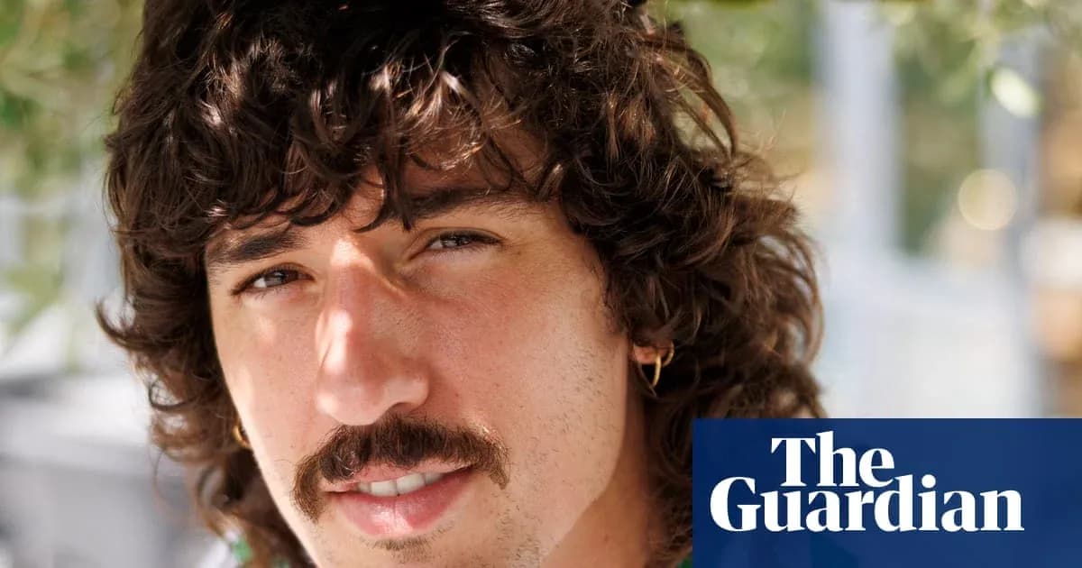 Man with curly hair and mustache smiling outdoors Man with curly hair and mustache smiling outdoors
