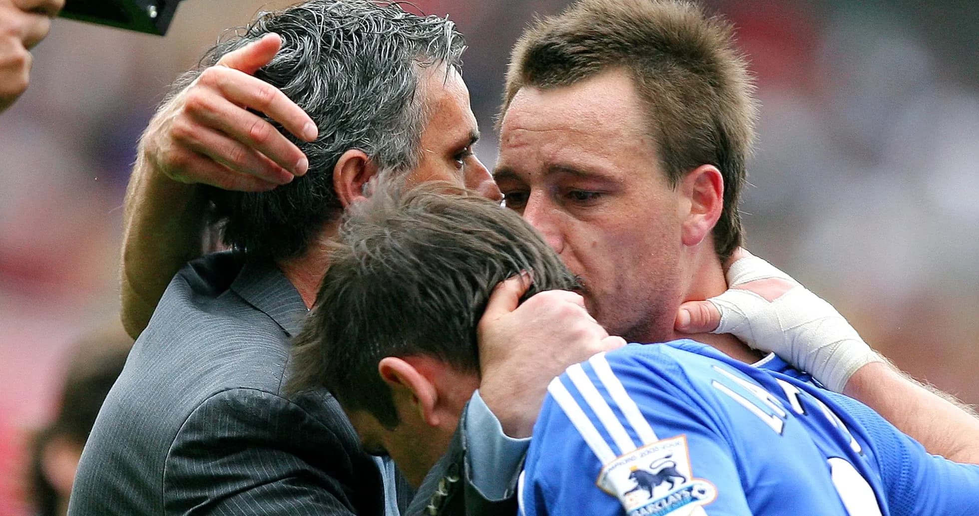 Players and manager embracing after match conclusion Players and manager embracing after match conclusion