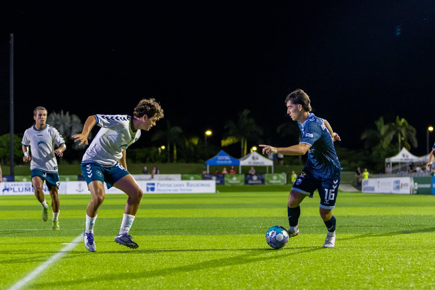 Players competing for the ball during match Players competing for the ball during match