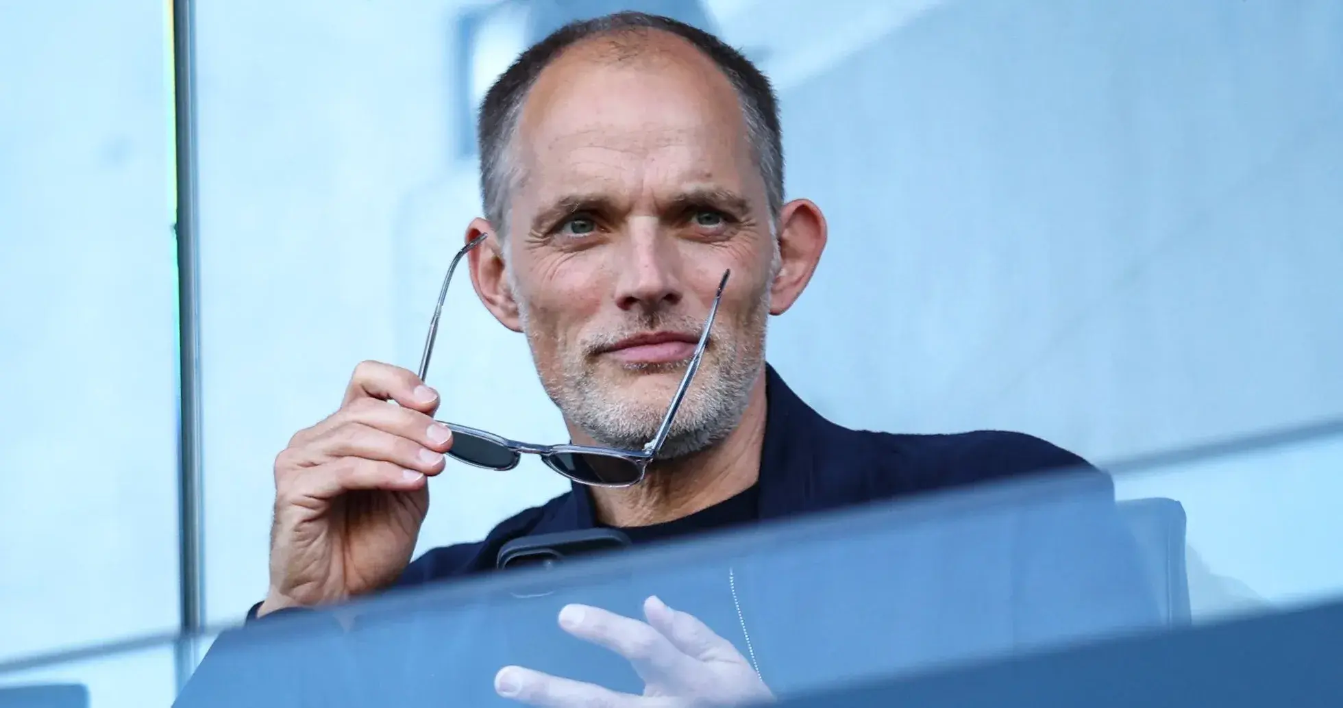 Man holding glasses in a stadium box Man holding glasses in a stadium box