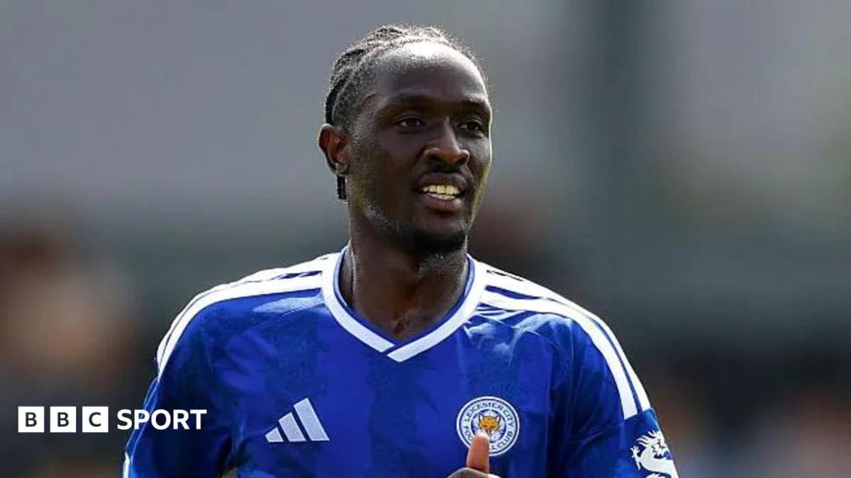 Player in blue Leicester City jersey running on field Player in blue Leicester City jersey running on field