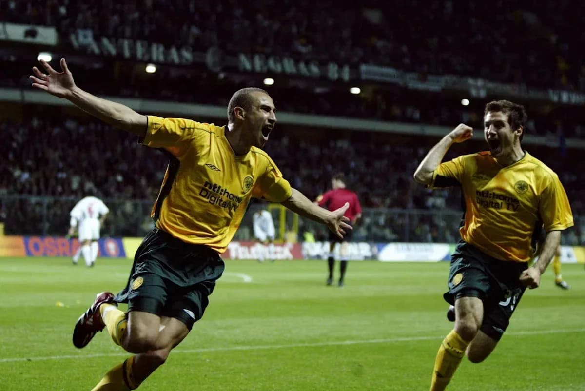 Two players celebrating a goal on the field Two players celebrating a goal on the field
