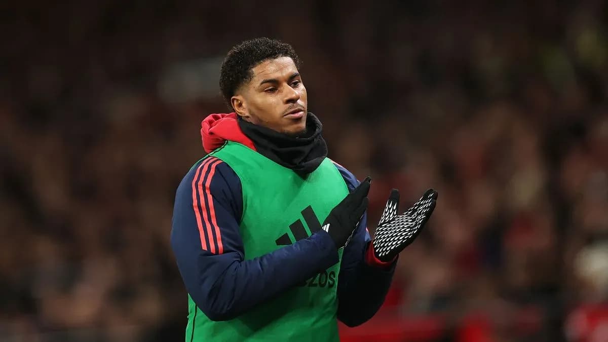 Player applauding while wearing training gear on sidelines Player applauding while wearing training gear on sidelines