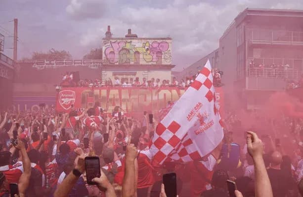 Arsenal fans celebrating with smoke and flags Arsenal fans celebrating with smoke and flags