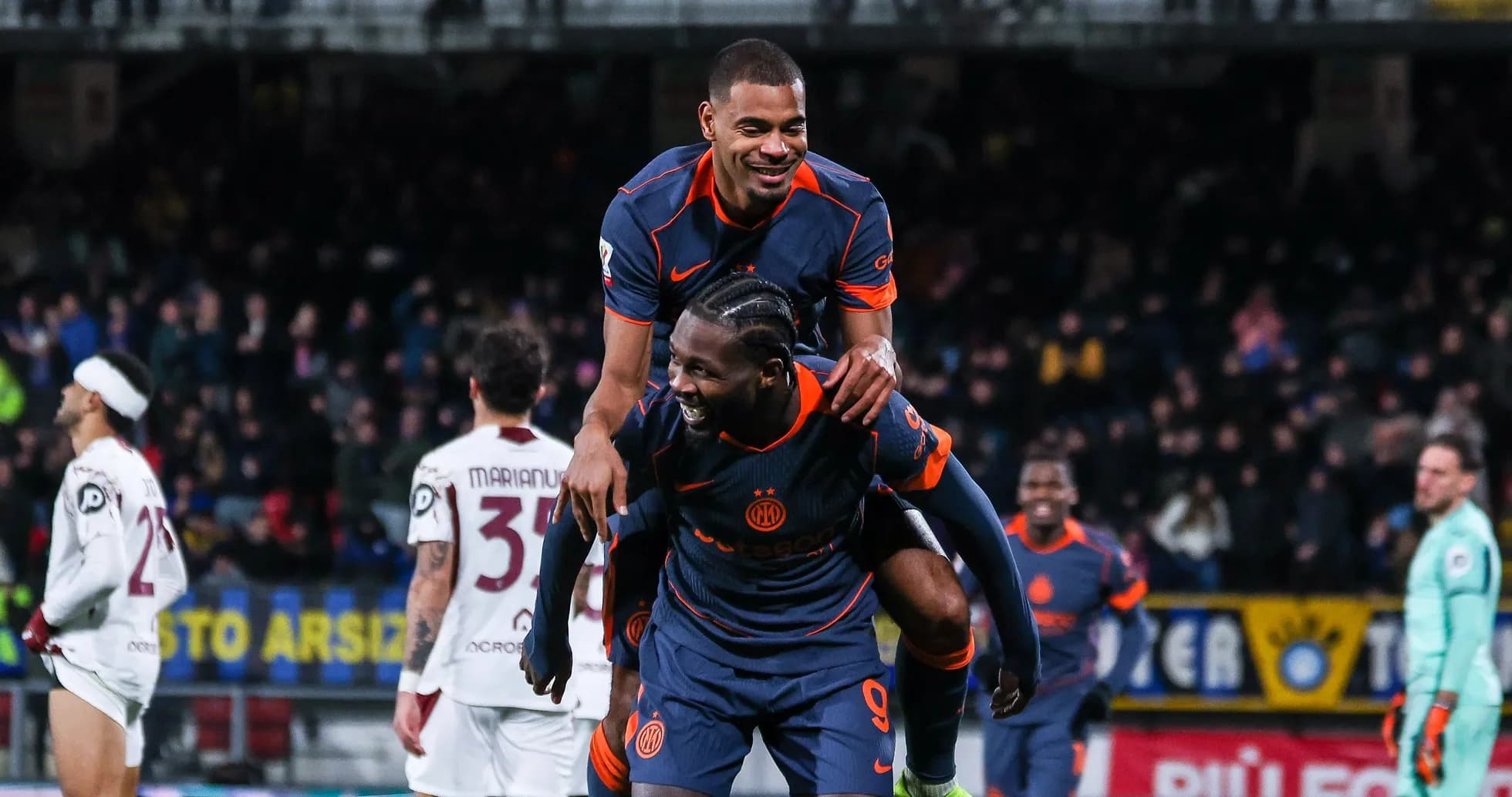 Players celebrating a goal on the field Players celebrating a goal on the field