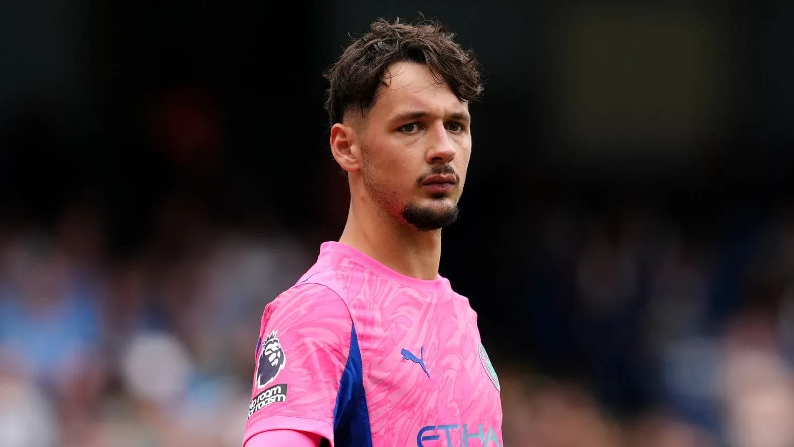 Goalkeeper in pink kit during match warm-up Goalkeeper in pink kit during match warm-up