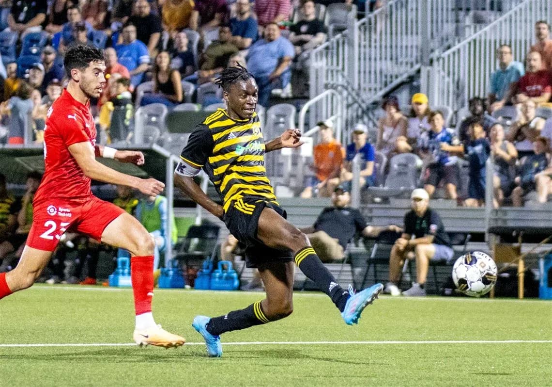 Pittsburgh Riverhounds player kicking the ball Pittsburgh Riverhounds player kicking the ball
