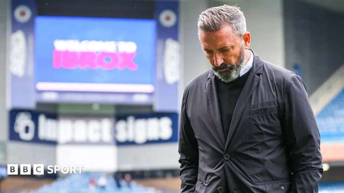 Manager walking with head down at Ibrox Stadium Manager walking with head down at Ibrox Stadium