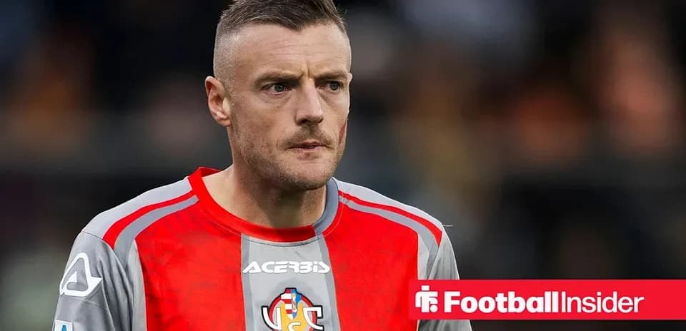 Goalkeeper in red and gray kit on field Goalkeeper in red and gray kit on field
