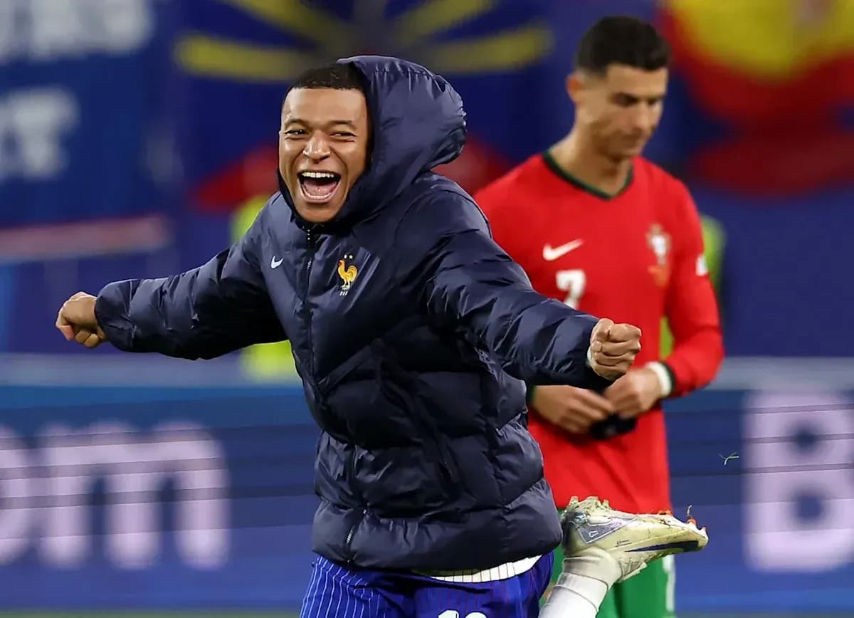 Player celebrating in winter jacket on field Player celebrating in winter jacket on field