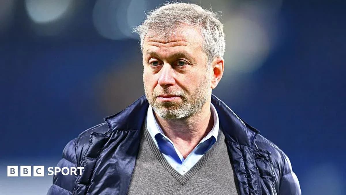 Man in a coat standing in a stadium Man in a coat standing in a stadium
