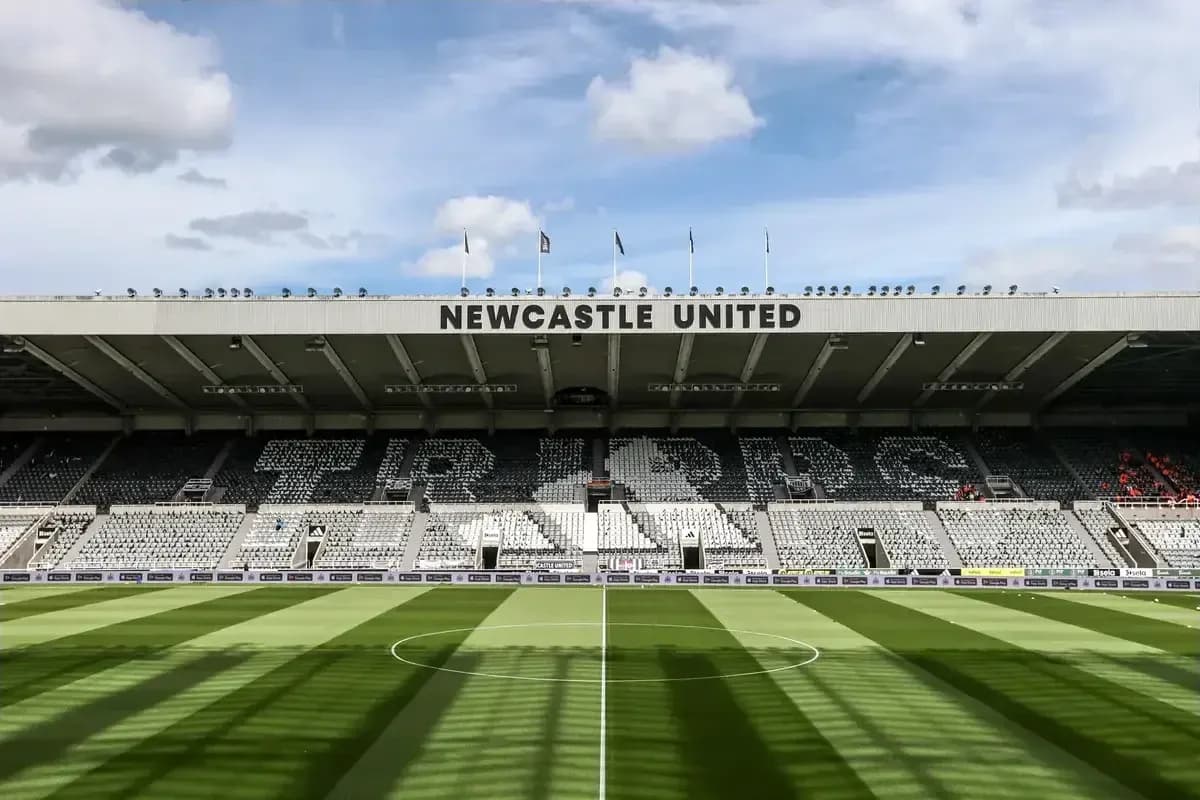 Newcastle United stadium with empty seats and green pitch Newcastle United stadium with empty seats and green pitch