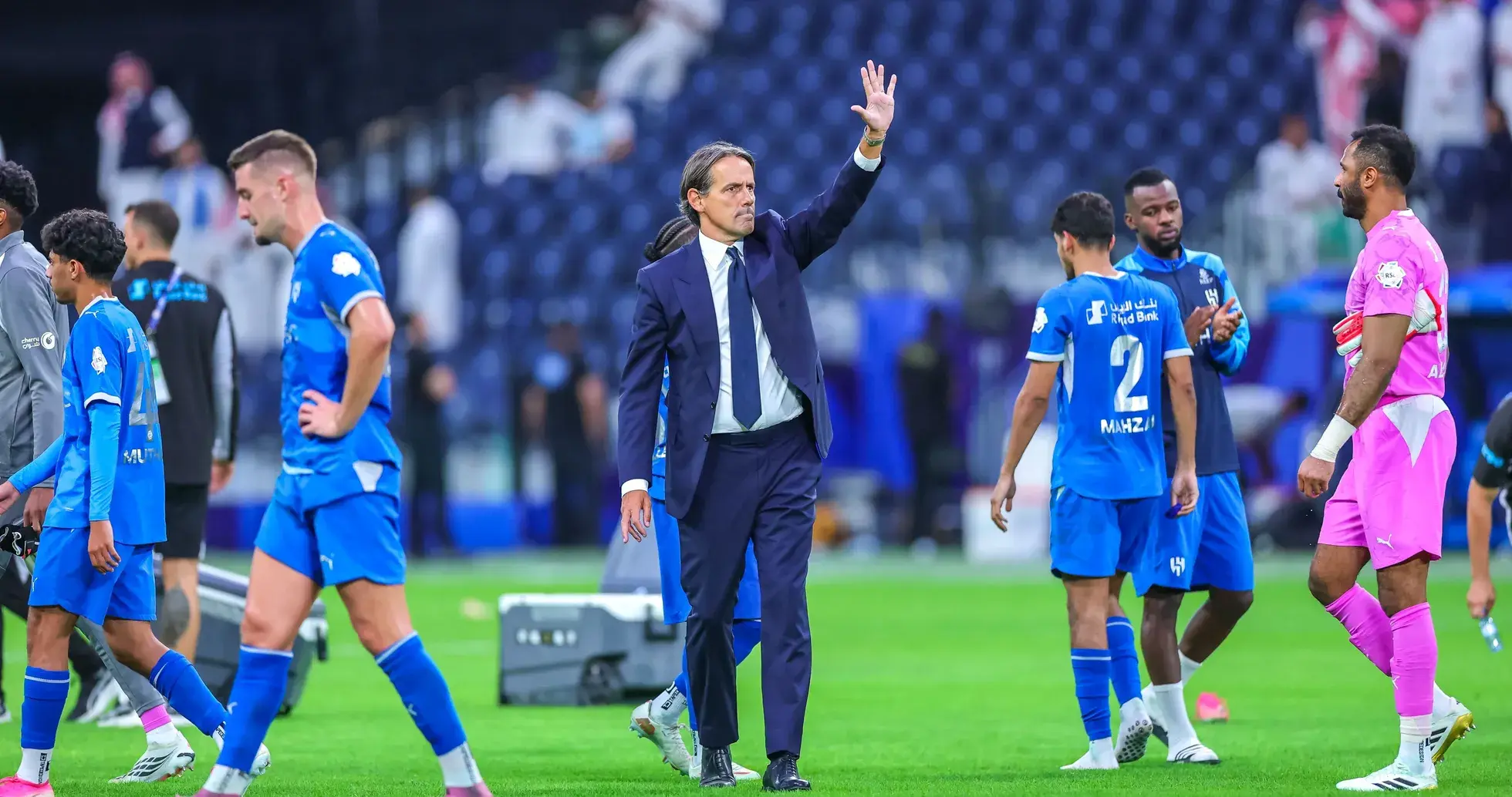Coach waving to players after match conclusion Coach waving to players after match conclusion
