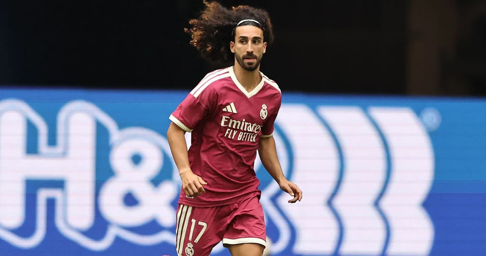Player running on the field in pink Real Madrid jersey Player running on the field in pink Real Madrid jersey