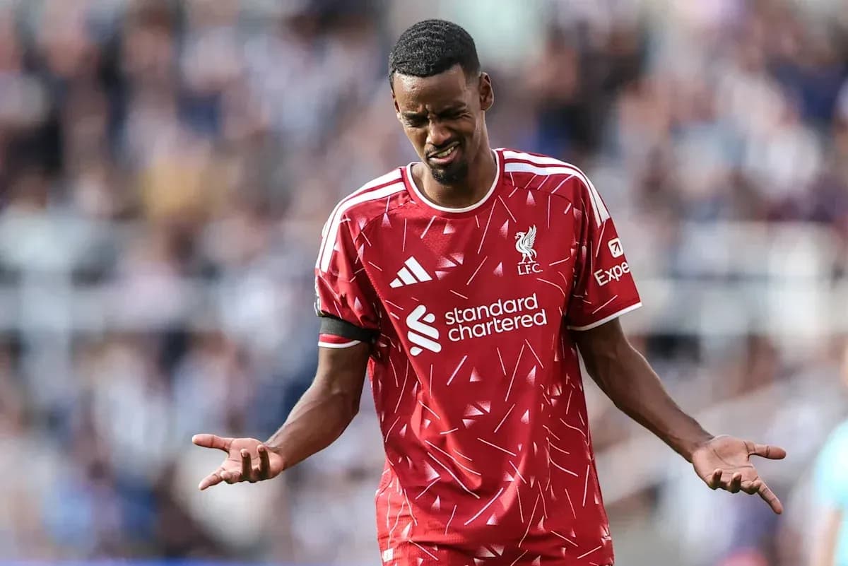 Player in Liverpool kit expressing frustration on pitch Player in Liverpool kit expressing frustration on pitch