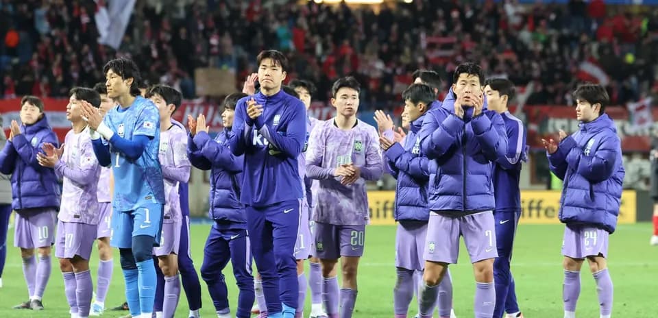 Team in purple jackets applauding fans after match Team in purple jackets applauding fans after match