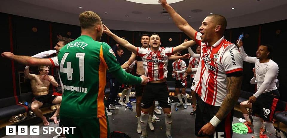Players celebrating in locker room after match Players celebrating in locker room after match