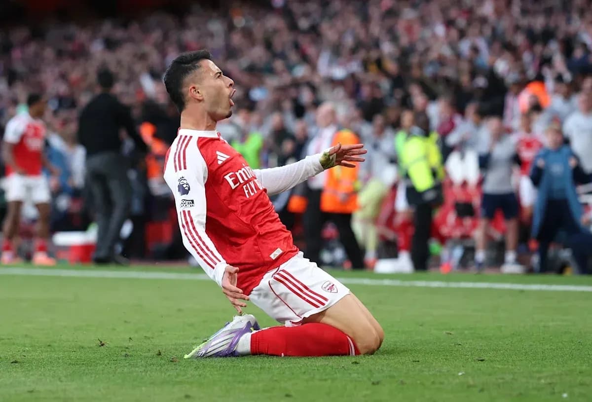 Arsenal player celebrating a goal on the pitch Arsenal player celebrating a goal on the pitch