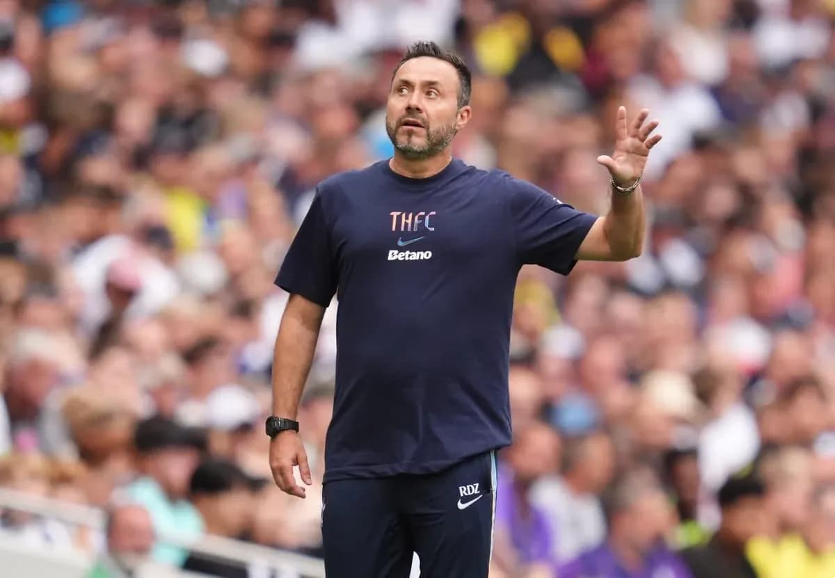 Coach gesturing during match in crowded stadium Coach gesturing during match in crowded stadium