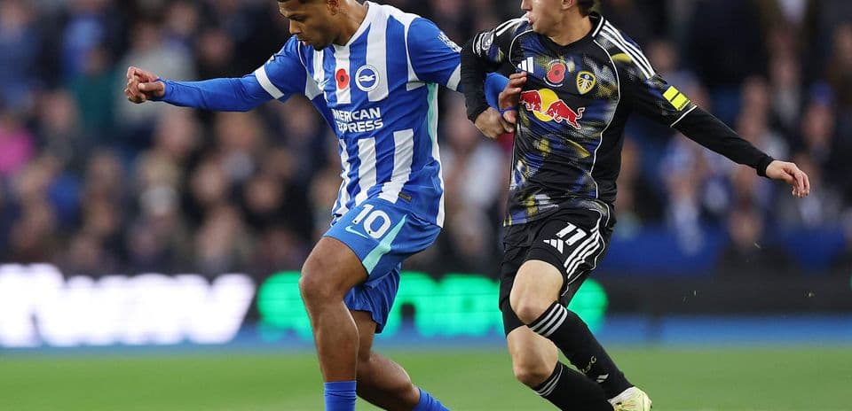Brighton player challenged by Leeds opponent Brighton player challenged by Leeds opponent