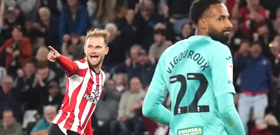 Player celebrating a goal with teammate nearby Player celebrating a goal with teammate nearby