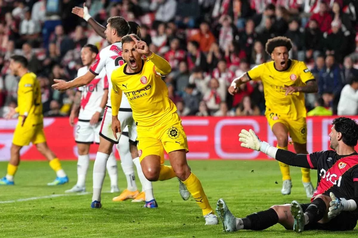 Player celebrating after scoring against the goalkeeper Player celebrating after scoring against the goalkeeper